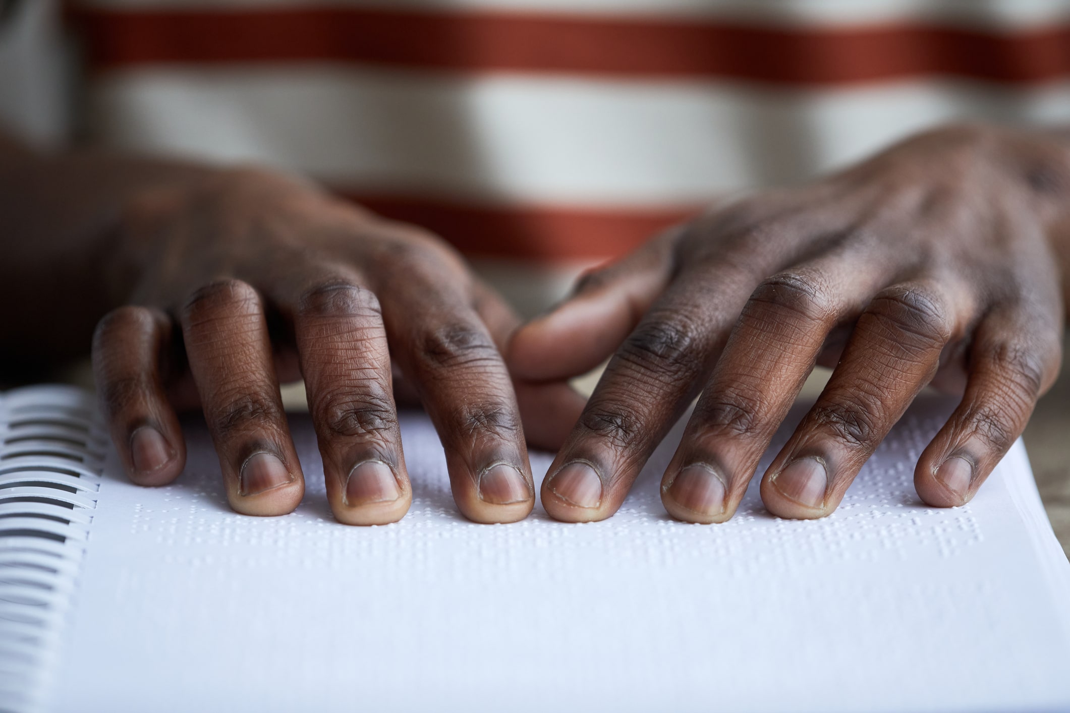 Picture of hands reading braille